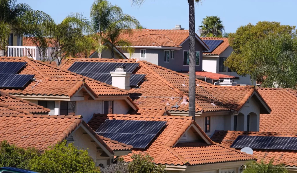 Residential neighborhood with multiple homes featuring rooftop solar panel systems