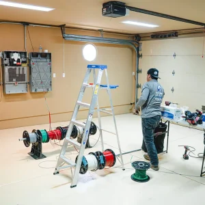 Residential garage setup with ladder, tools, and equipment for solar installation